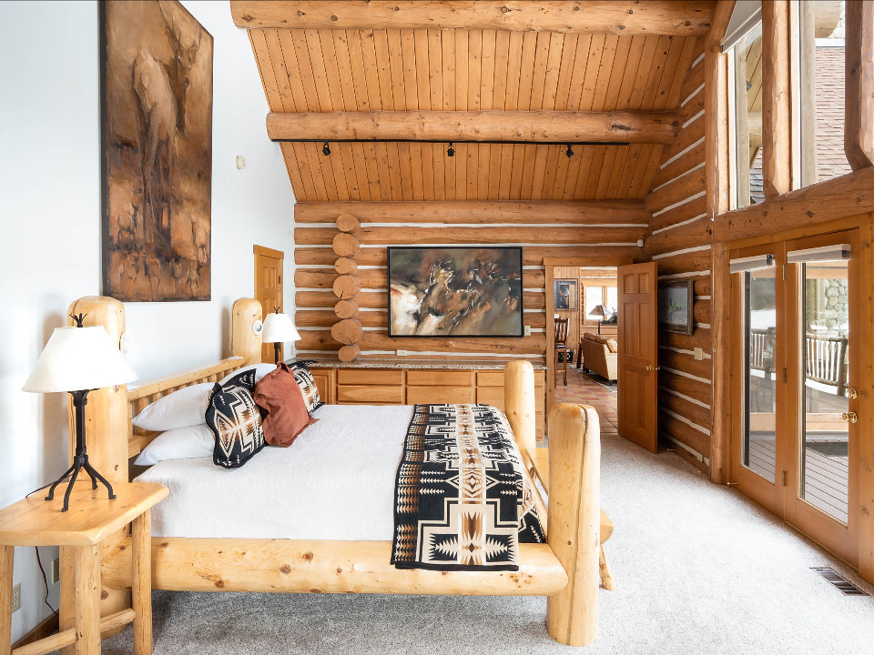 Stage Stop bedroom with large western artwork and log features
