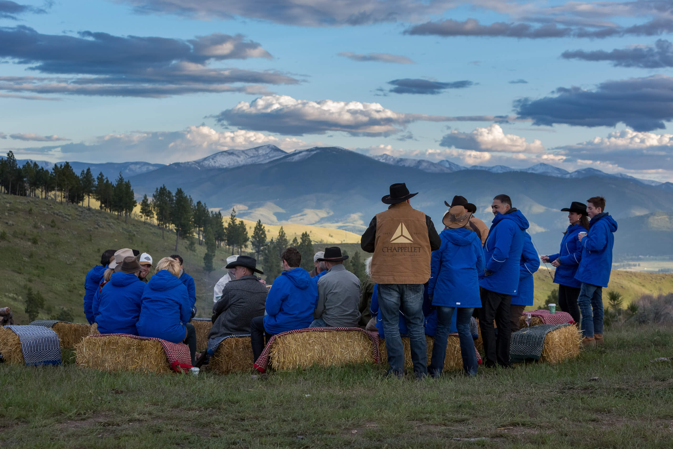 Group of folks gathered on top of the mountain