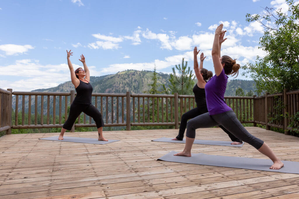 Guests practicing yoga on the observation deck overlooking the Mountain View