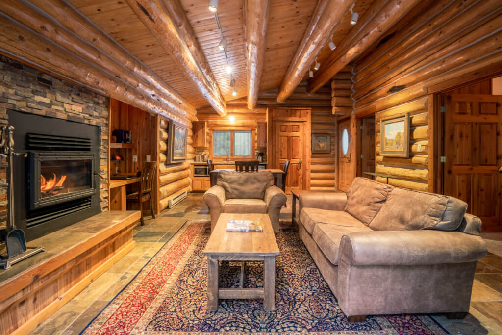 Log cabin style living room in two bedroom luxury cabin