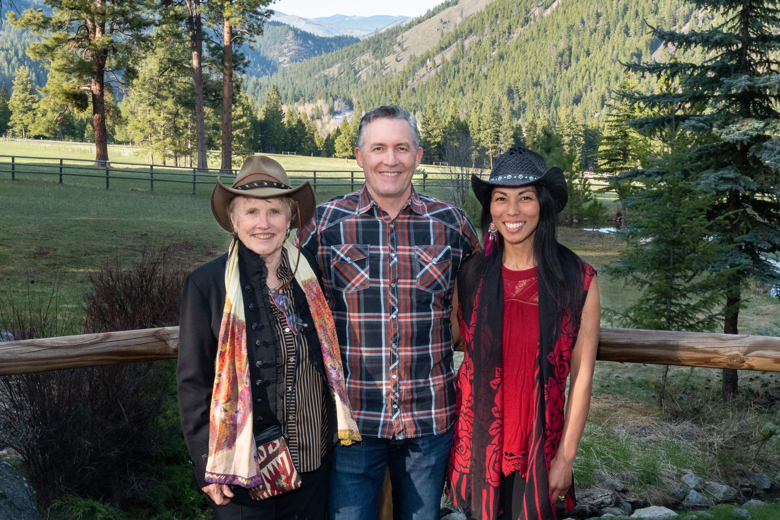 Artist Workshop Artists Nancy Cawdrey, Jason Rich, and Brenna Kimbro standing in front of mountain landscape.