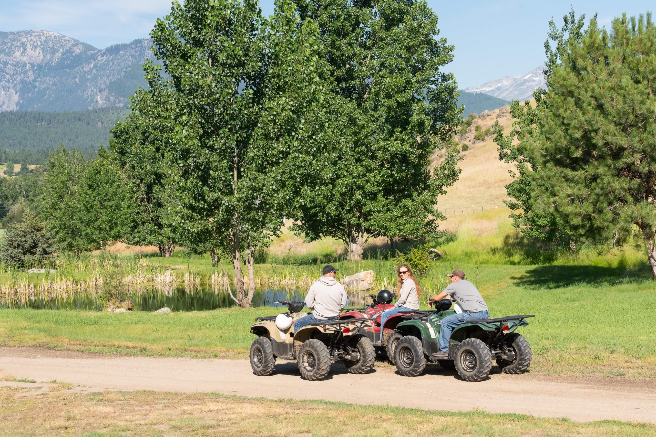 Guests riding ATVs across a mountain landscape