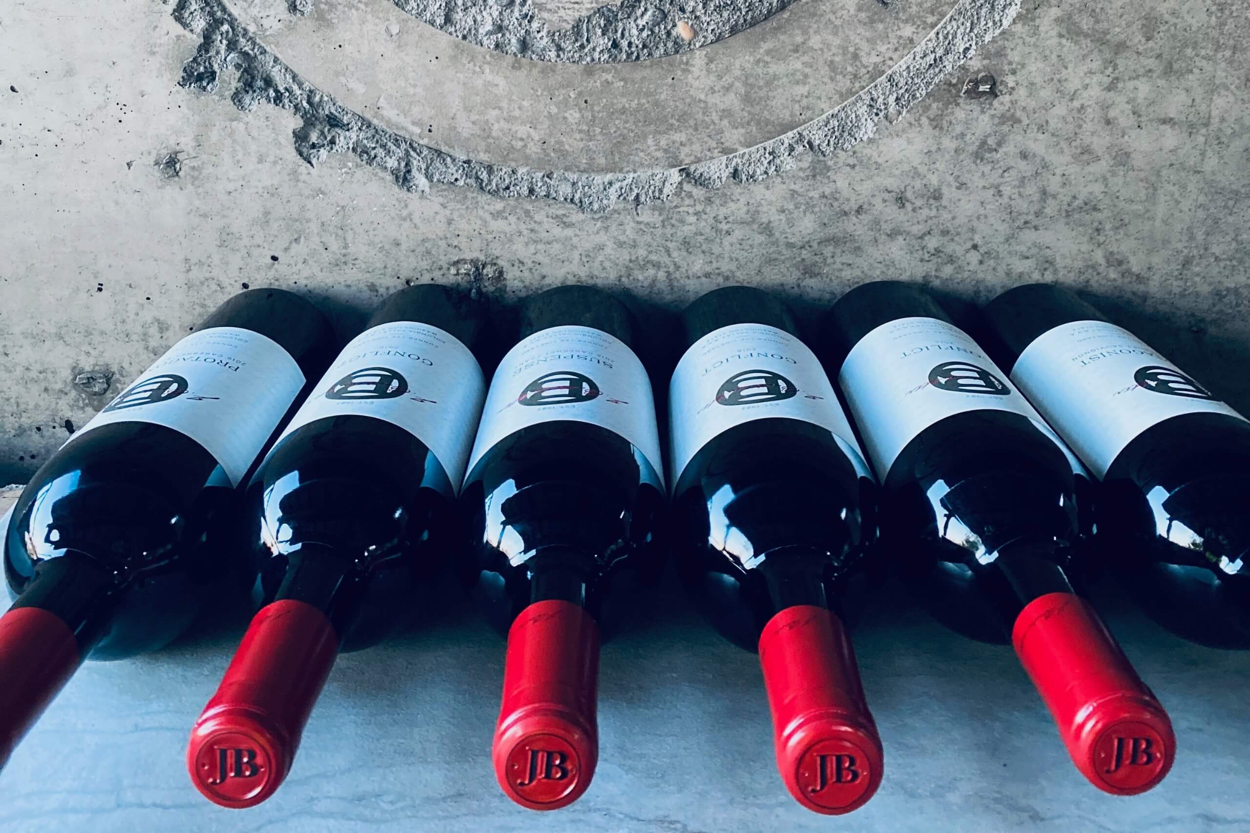 J Bookwalter wine bottles lined up on a table.