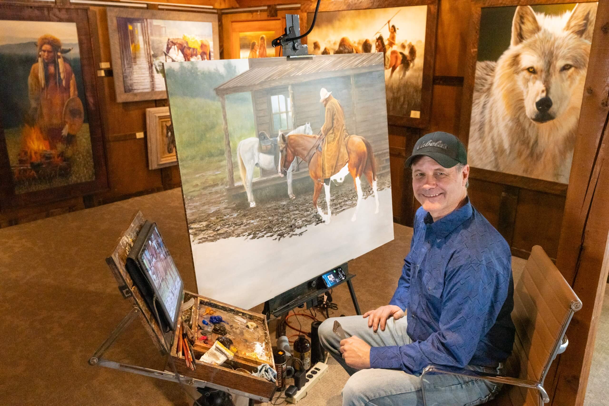 Artist Joe Kronenberg paining a horse and cowboy.