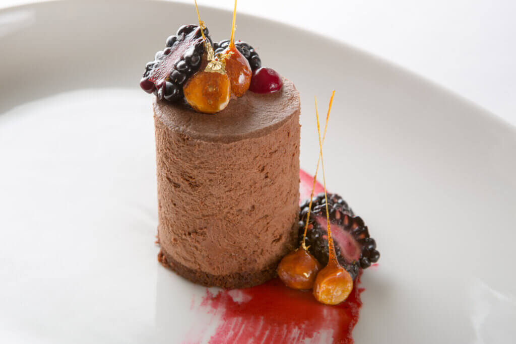 Dark Chocolate Mousse on Chocolate Cake with Blackberry Coulis, Fresh Blackberries and Caramelized Hazelnuts. Cuisine