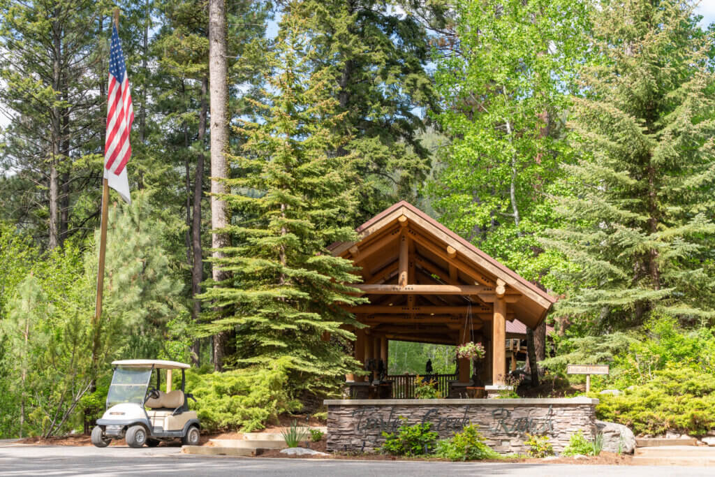 Triple Creek Ranch Lodge Portico Entry Flagpole Sign and Golf Cart