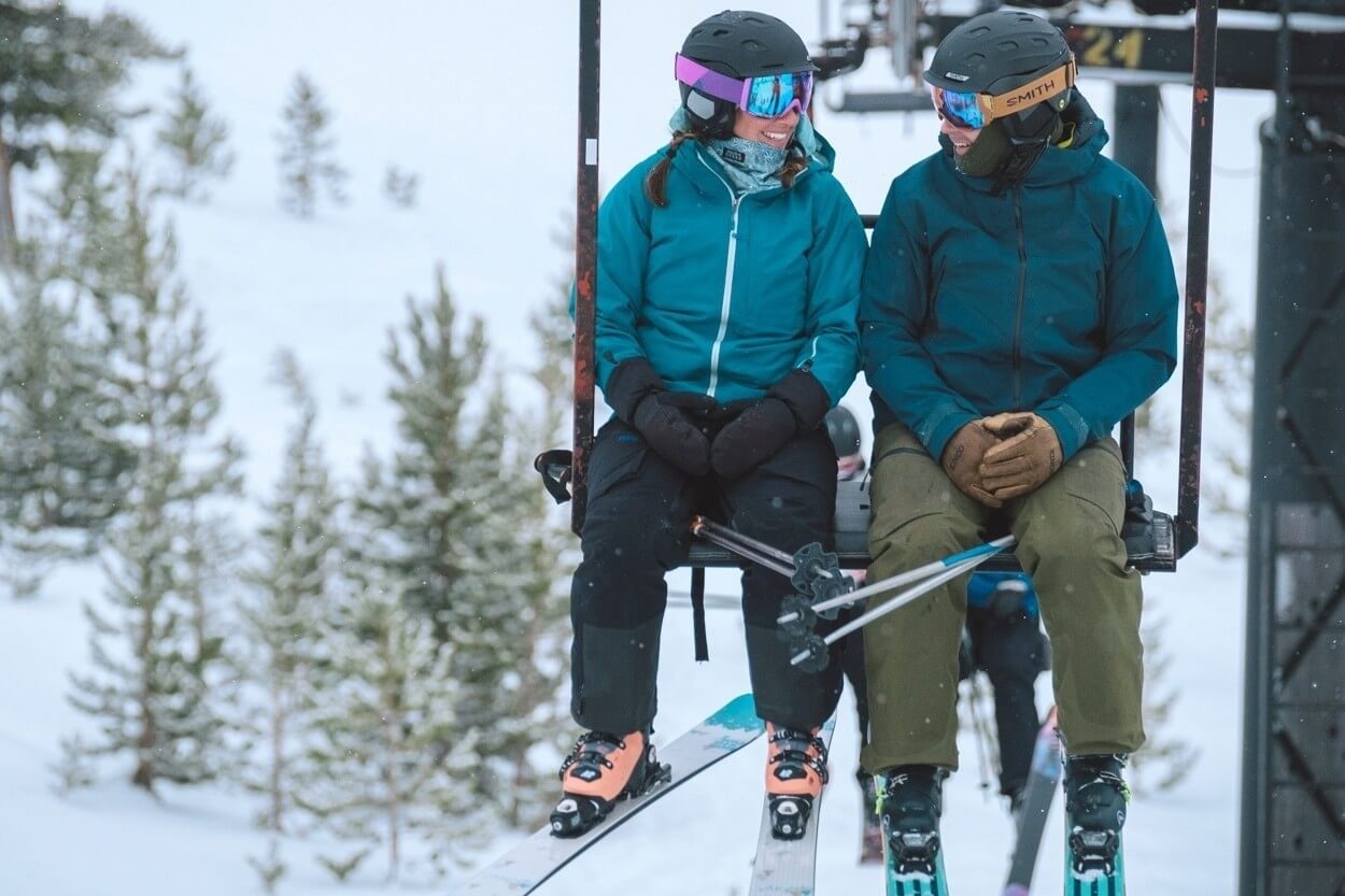 Lost Trail Ski Area Lift Chair Couple with Triple Creek Ranch Ski and Sip Event