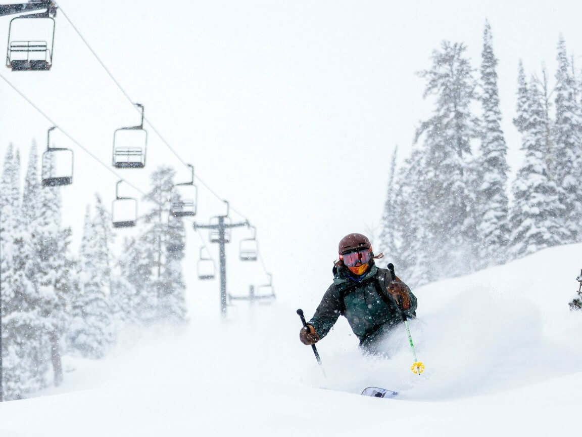 Lost Trail Ski Area Skiing through fresh powder by chair lift